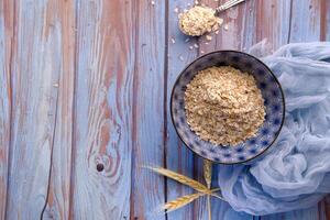 high angle view of oats flakes in a bowl with copy space photo