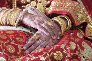 Close up of indian bride hand with jewelry photo