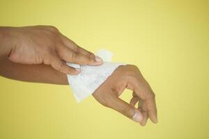 man disinfecting his hands with a wet wipe. photo