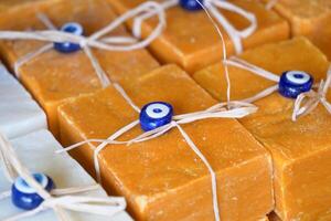 Stack of soap topped with evil eye beads, photo