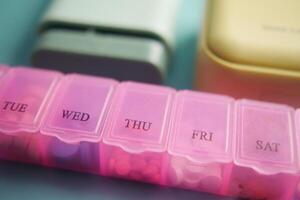 close up of medical pills in a pill box on table photo