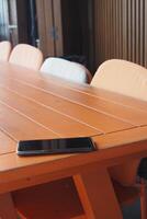 forget smartphone on a cafe table, lost smart phone photo