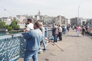 Turkey istanbul 12 january 2023. Fishermen on the fishing road Galata Bridge photo