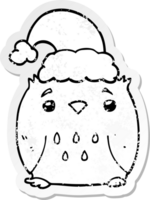 distressed sticker of a cute cartoon owl wearing christmas hat png