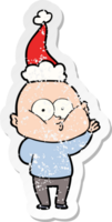 hand drawn distressed sticker cartoon of a bald man staring wearing santa hat png