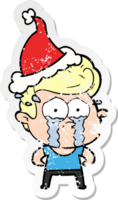 hand drawn distressed sticker cartoon of a crying man wearing santa hat png