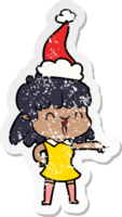 hand drawn distressed sticker cartoon of a happy girl wearing santa hat png