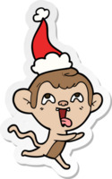 fou main tiré autocollant dessin animé de une singe fonctionnement portant Père Noël chapeau png