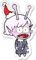 hand drawn distressed sticker cartoon of a shocked alien girl wearing santa hat png