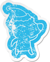 quirky cartoon distressed sticker of a whistling bear wearing santa hat png