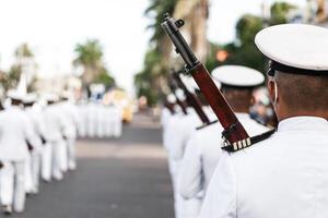 Navy personnel in formation holding a war rifles photo