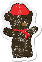 retro distressed sticker of a cartooon cute black bear in hat and scarf png