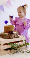 linda pequeño niño niña celebrar su cumpleaños y lame piruletas en un dulce pastel video