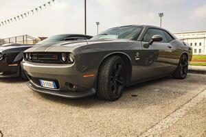 Vicenza Italy 19 March 2024 A Dodge Challenger stands out parked among enthusiasts at a car rally photo