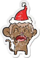 shouting hand drawn distressed sticker cartoon of a monkey wearing santa hat png