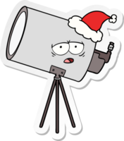 hand drawn sticker cartoon of a bored telescope with face wearing santa hat png