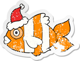 hand drawn distressed sticker cartoon of a exotic fish wearing santa hat png