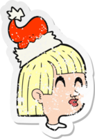 retro distressed sticker of a cartoon girl wearing santa hat png