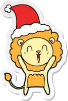 en riant Lion main tiré autocollant dessin animé de une portant Père Noël chapeau png