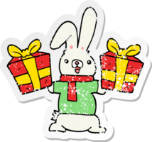 distressed sticker of a cartoon rabbit with christmas presents png