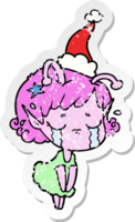 hand drawn distressed sticker cartoon of a crying alien girl wearing santa hat png