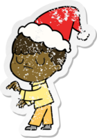 hand drawn distressed sticker cartoon of a grumpy boy wearing santa hat png