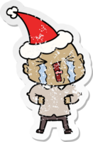 hand drawn distressed sticker cartoon of a crying bald man wearing santa hat png