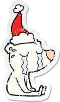 hand drawn distressed sticker cartoon of a crying sitting polar bear wearing santa hat png