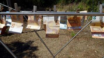 50 and 20 euro banknotes hung out to dry on a drying rack photo