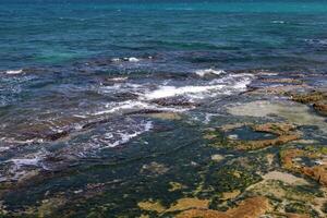 The color of water in the Mediterranean Sea in shallow water. Natural abstract background. photo