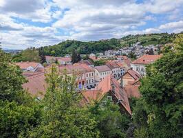 Beautiful cityscape scenery of buildings and architecture in old town surrounded by forest and hills at Krapina, Croatia, County Hrvatsko zagorje photo