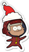 caricatura de pegatina de astronauta feliz de un sombrero de santa que lleva puesto png