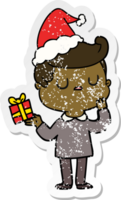 distressed sticker cartoon of a man wondering wearing santa hat png