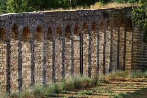 An ancient aqueduct for supplying water to populated areas. photo