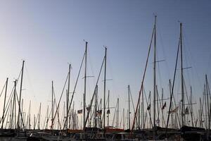 Masts in the port against the blue sky. photo