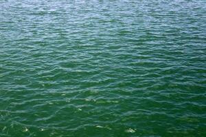 The color of water in the Mediterranean Sea in shallow water. Natural abstract background. photo