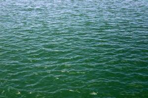 The color of water in the Mediterranean Sea in shallow water. Natural abstract background. photo