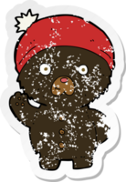 retro distressed sticker of a cartoon waving black teddy bear in winter hat png