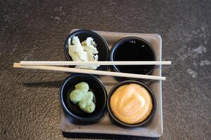 On the table in a sushi restaurant is a dish of traditional Japanese cuisine. photo