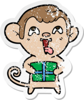 distressed sticker of a crazy cartoon monkey with christmas present png
