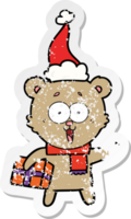 laughing teddy  bear with christmas present wearing santa hat png