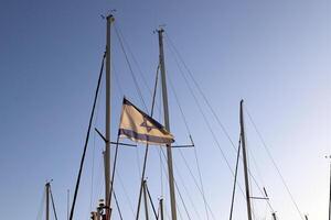 Masts in the port against the blue sky. photo