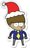 nerveux main tiré autocollant dessin animé de une garçon portant chemise et attacher portant Père Noël chapeau png