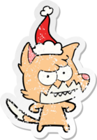 hand drawn distressed sticker cartoon of a grinning fox wearing santa hat png