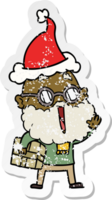 hand drawn distressed sticker cartoon of a joyful man with beard and parcel under arm wearing santa hat png