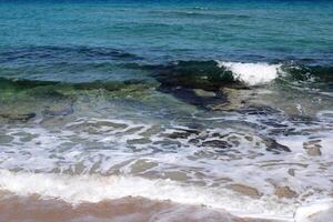 The color of water in the Mediterranean Sea in shallow water. Natural abstract background. photo