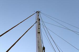 Masts in the port against the blue sky. photo