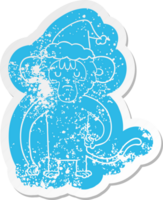 quirky cartoon distressed sticker of a monkey scratching wearing santa hat png