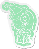 quirky cartoon distressed sticker of a cyclops alien spaceman wearing santa hat png