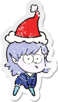 hand drawn distressed sticker cartoon of a elf girl staring and crouching wearing santa hat png